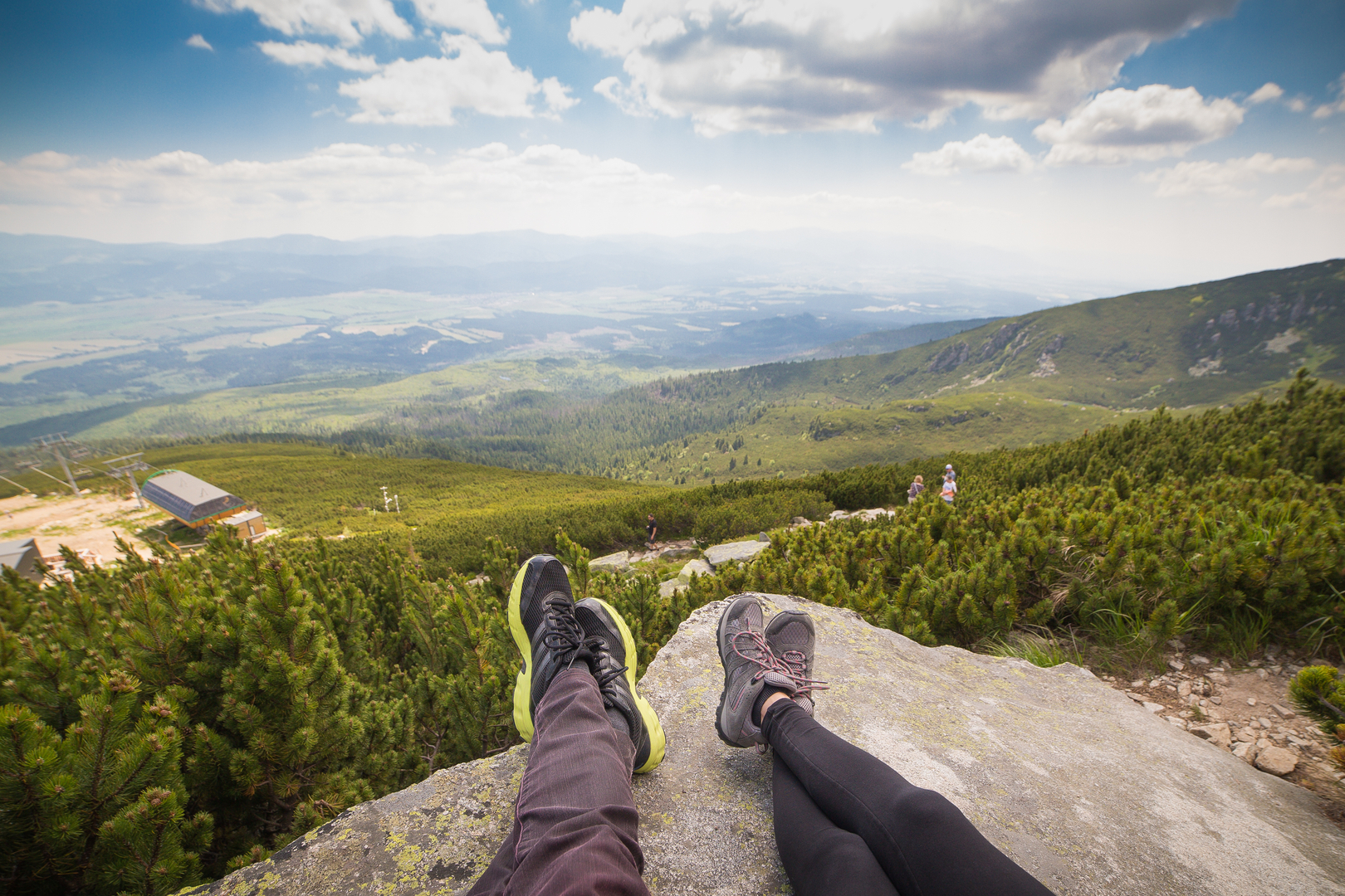 People overlooking a green mountain landscape